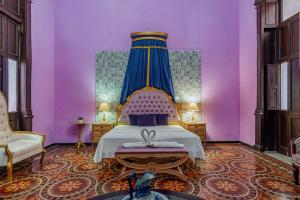 a bedroom with a bed with a blue canopy at Hotel Lavanda CAS Merida in Mérida