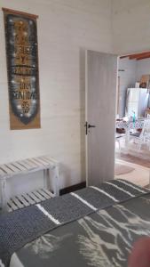 a room with a bed and a door and a table at Cabaña de las mariposas in Tigre