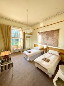 a bedroom with two beds and a large window at Newington House in Edinburgh