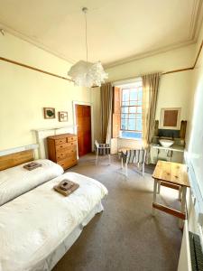 a bedroom with two beds and a desk and a sink at Newington House in Edinburgh