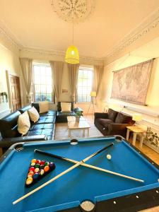 a living room with a pool table in the middle of it at Newington House in Edinburgh