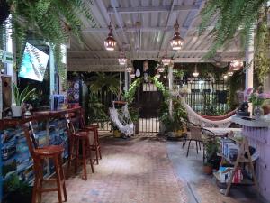 a restaurant with chairs and a bar with plants at Casa Linda in Santa Marta