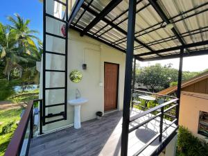 a view of a bathroom from the balcony of a house at Chaisuk Bungalow in Aranyaprathet