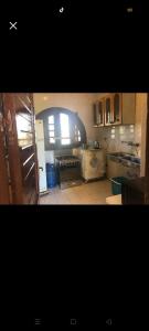 a kitchen with an open door to a kitchen with a stove at chalet for rent at marina 7 el alamein 4 bedrooms air conditions marina card in El Alamein