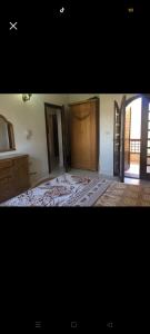 an empty room with a bed and a wooden door at chalet for rent at marina 7 el alamein 4 bedrooms air conditions marina card in El Alamein