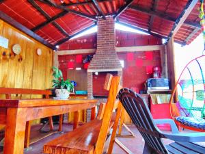 a dining room with a wooden table and a fireplace at CABAÑA tipo habitación con PALAPA y Asador Planta Alta en Zacatlán in Zacatlán