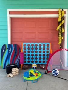 a garage door with a bunch of toys in front of it at Sea Glass Cottage in Crystal Beach