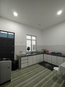 a kitchen with a sink and a counter top at Qayyum Homestay Pauh Lima,Bachok,Kelantan in Bachok