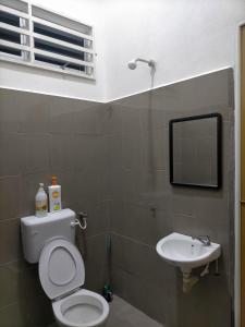 a bathroom with a toilet and a sink at Qayyum Homestay Pauh Lima,Bachok,Kelantan in Bachok