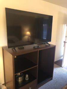 a large flat screen tv on a stand in a room at Red Lion Inn and Suites La Pine, Oregon in La Pine
