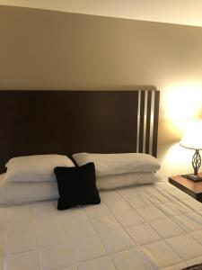 a bedroom with a large bed with a black headboard at Red Lion Inn and Suites La Pine, Oregon in La Pine