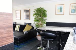 a living room with a bar and a couch at Misty Isle Apartments Ltd - Maol View in Kyleakin