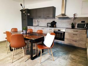 a kitchen with a wooden table and orange chairs at Bellavista Resort in Koper