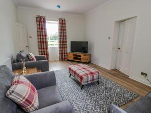 a living room with two couches and a television at North Firbank - Culzean Castle in Maybole