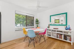 a dining room with a table and chairs and a mirror at Graebill 2 Bedroom 2 Bathroom Light and Spacious Duplex Walk to Beach Great Outdoor Entertaining Area in Sunshine Beach