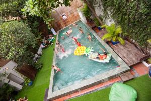 a pool of water with people playing in it at Mad Monkey Hostel Phnom Penh in Phnom Penh