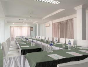 uma sala de conferências com mesas e cadeiras com garrafas de água em Hotel Tulsi em Pokhara