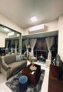 a living room with a couch and a table at Mactan Newtown - New Modern Condo with Ocean View in Mactan