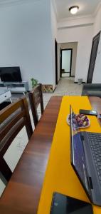 a laptop computer sitting on a wooden table at Cozy 1-bedroom luxury Apartment in Addis Ababa