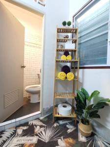 a bathroom with a toilet and a shelf at Aim Houze in Udon Thani