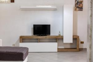 a living room with a television on a table at SanvitoTour - Appartamenti Tajine in San Vito lo Capo