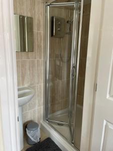 a bathroom with a shower and a sink at Garden flat near the University of York in York