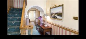 a room with a staircase and a table and a stair case at Atlantic Lodge in Galway