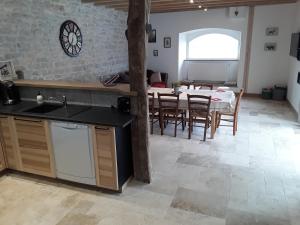 a kitchen and dining room with a table and chairs at Gite de la Diligence in Le Fied
