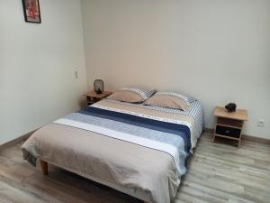 a bedroom with a bed and two night stands at La Teranga proche La Rochelle in Nuaillé-dʼAunis