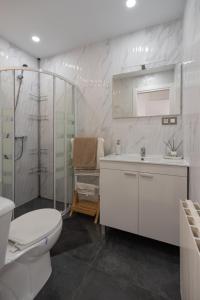 a bathroom with a toilet and a sink and a shower at DREAM HOUSE in Burriana