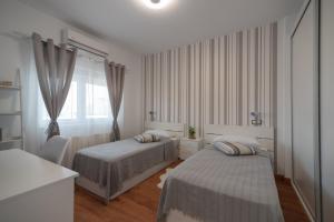a bedroom with two beds and a window at DREAM HOUSE in Burriana +28 photos