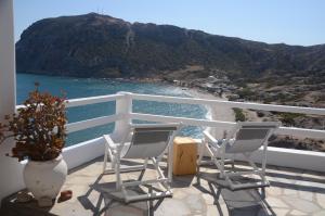 two chairs on a balcony with a view of the ocean at Agia Kyriaki Studios in Agia Kiriaki Beach