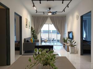 a living room with a couch and a ceiling fan at Dream 3 @ Emerald avenue in Brinchang
