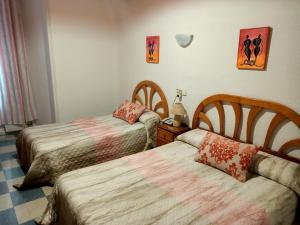 Postel nebo postele na pokoji v ubytování Hostal Continental