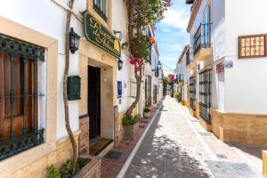 an alley in an old town in spain at Puerta De Aduares in Marbella