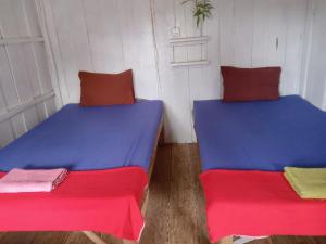 Ένα ή περισσότερα κρεβάτια σε δωμάτιο στο Happiness Guesthouse
