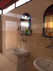 a bathroom with a sink and a bath tub at Bedouin Expedition in Wadi Rum