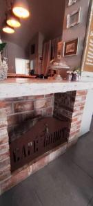 a bar with a brick counter with a sign on it at Godot Apartman in Miskolc