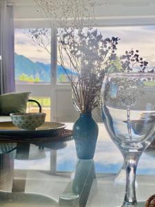 a glass vase with flowers in it on a table at Chez Tata Emma in Annecy