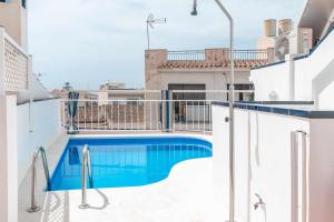 a swimming pool on the roof of a building at Apartamentos Alan in Nerja