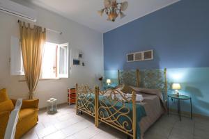 una camera blu con un letto e un divano di Corte dei Donno a Santa Maria al Bagno Altre 86 foto