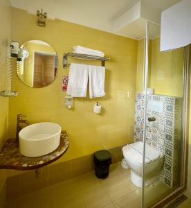 a bathroom with a toilet and a sink and a mirror at H by Hambar in Vama Veche +59 photos