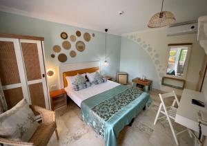 a bedroom with a bed and a chair in it at H by Hambar in Vama Veche