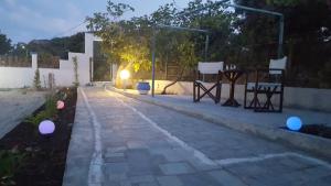 a stone walkway with lights on the side of a building at Villa Bel Passo Apartments in Kefalos