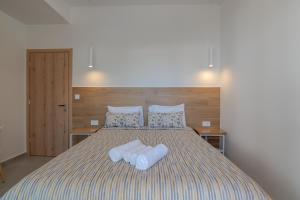 a bedroom with a bed with two towels on it at Secret Nest in Plakias