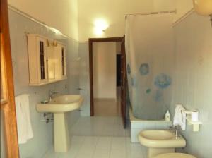 y baño con lavabo, aseo y ducha. en Casa Vacanze Costa Ovest, en Terralba