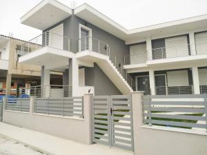 a house with a white fence and a gate at Luxury Villa Siniori in Keramoti