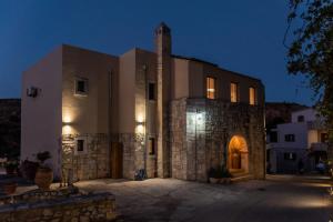 a large stone building with a clock tower on top at Casa Prasoul Villa with Heated Pool & Fitness area in Prasiaí