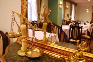 a mirror sitting on top of a table with bells at Old Time Hotel in Kraków