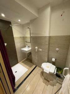 La salle de bains est pourvue de toilettes et d'un lavabo. dans l'établissement Hotel San Biagio, à Milan